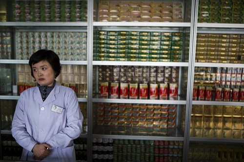 In this Feb. 21, 2013 photo, a pharmacist waits for customers at the Man Nyon Pharmacy, the nation's largest dispensary of traditional "Koryo" medicine, in Pyongyang, North Korea. North Korea began marrying traditional medicine with modern practice in the 1950s after the Korean War. (AP Photo/David Guttenfelder)
